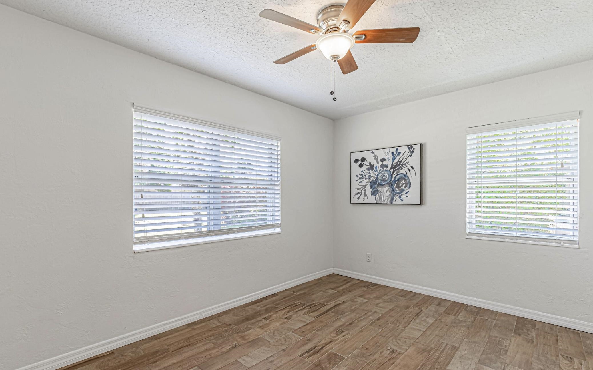 6154 Temple Road Jacksonville, FL 32217 - Photo 13 of 25 a view of an empty room with a window and wooden floor