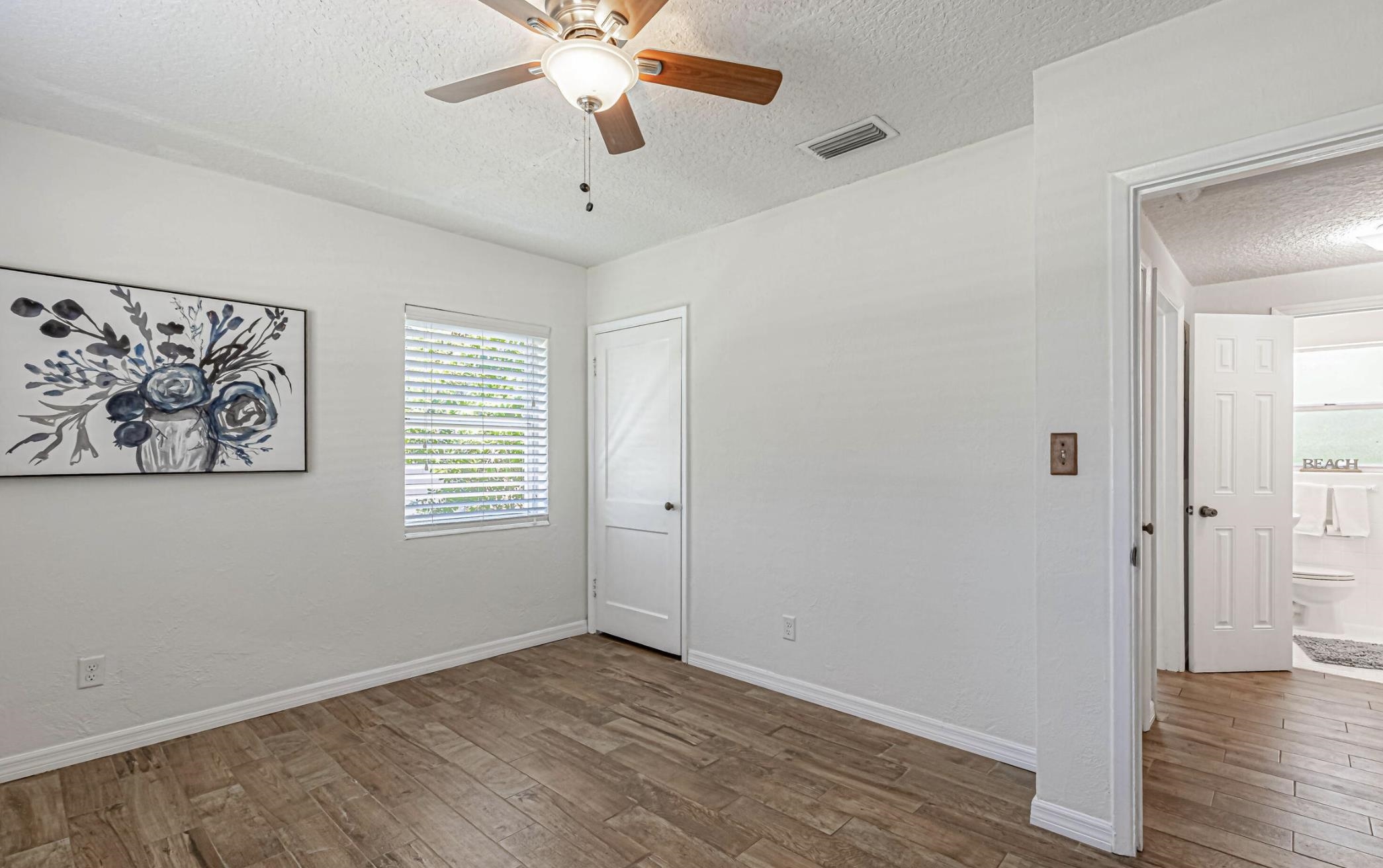 6154 Temple Road Jacksonville, FL 32217 - Photo 14 of 25 a view of an empty room with wooden floor and a window