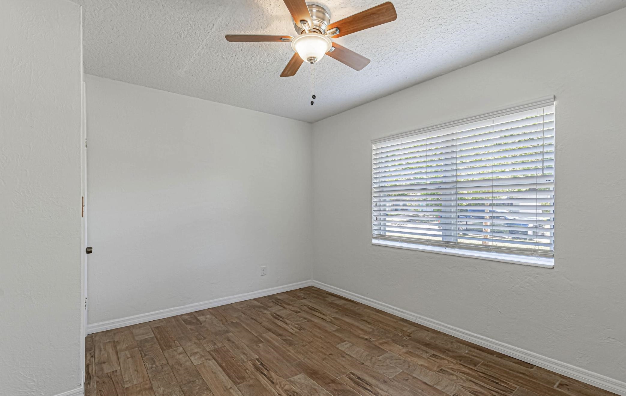 6154 Temple Road Jacksonville, FL 32217 - Photo 16 of 25 a view of an empty room with window and a chandelier fan