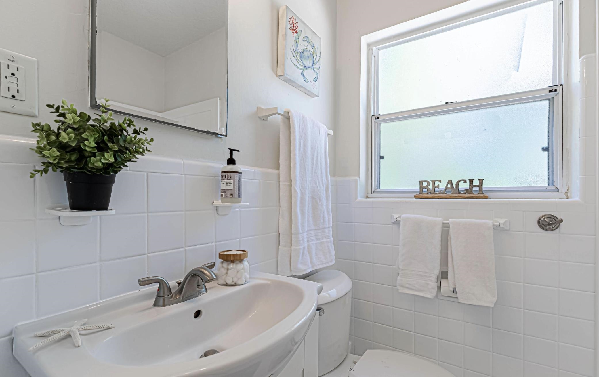 6154 Temple Road Jacksonville, FL 32217 - Photo 17 of 25 a bathroom with a sink a toilet and mirror