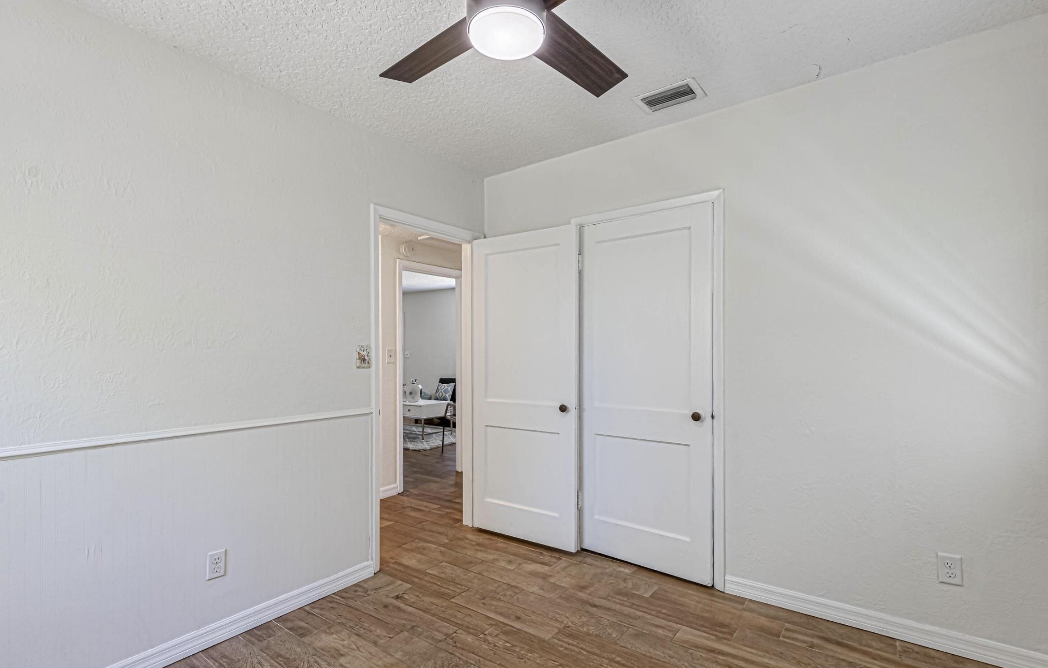 6154 Temple Road Jacksonville, FL 32217 - Photo 20 of 25 an empty room with wooden floor closet and windows