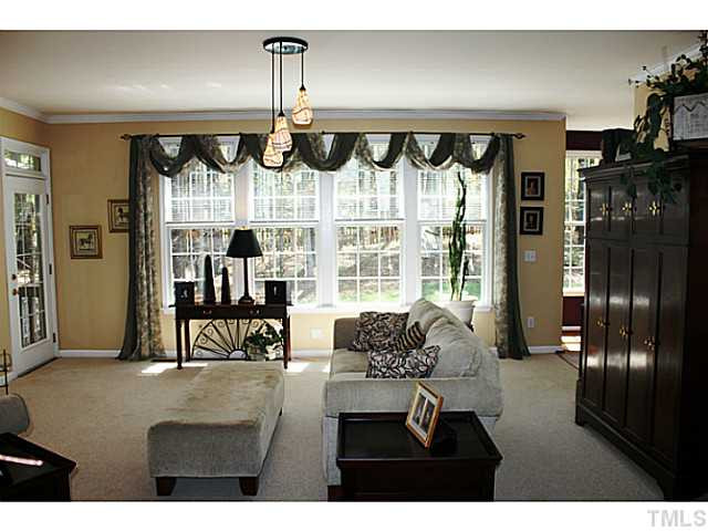 Great wall of windows in living room makes this room so pleasant.