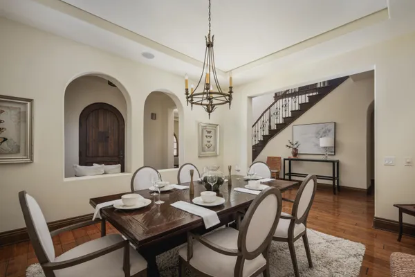 a bedroom with a bed couch and windows