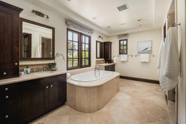 a bathroom with a shower sink and mirror