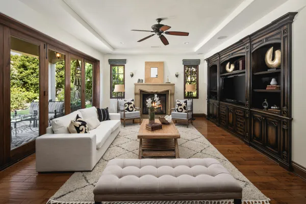 a living room with furniture fireplace and flat screen tv