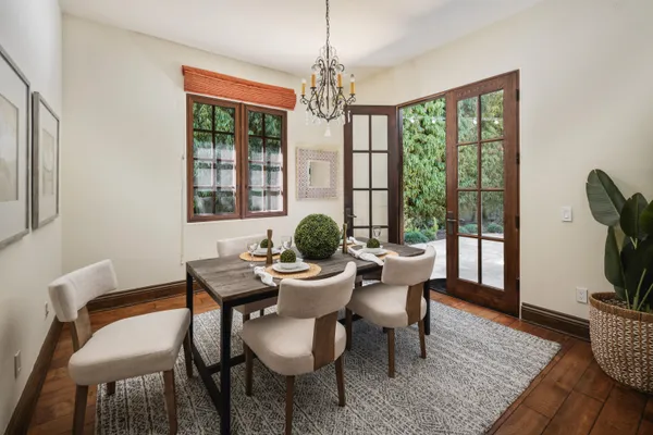 a view of a a dining room with furniture window and wooden floor