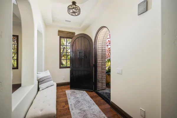 a view of entryway and hall with wooden floor