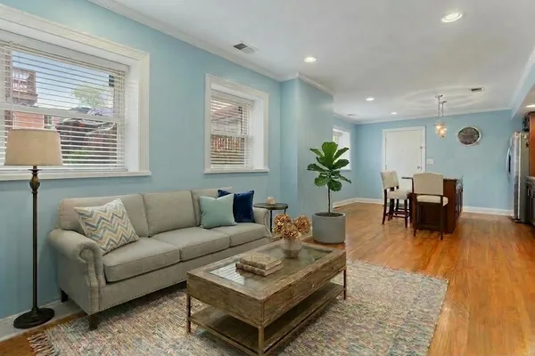 a kitchen with stainless steel appliances granite countertop a refrigerator a sink a stove and a wooden floors