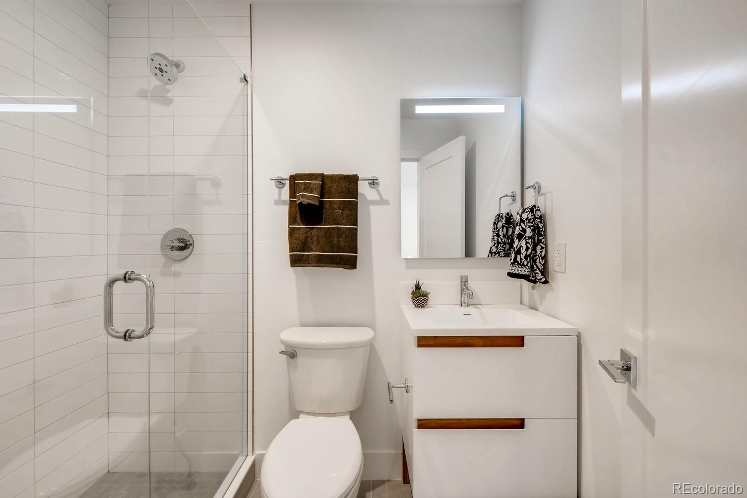 234 Inca Street Denver, CO 80223 - Photo 14 of 27 a bathroom with a sink toilet and shower