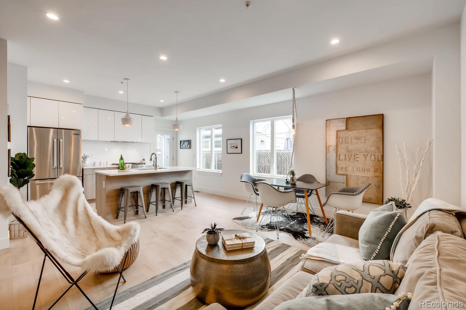 234 Inca Street Denver, CO 80223 - Photo 7 of 27 a living room with furniture and a dining table with kitchen view