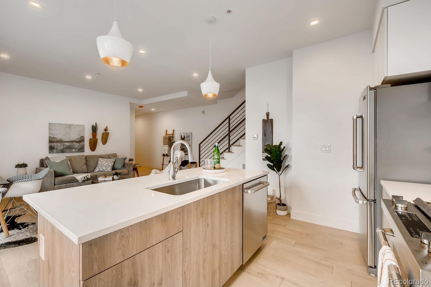 234 Inca Street Denver, CO 80223 - Photo 8 of 27 a view of a kitchen area kitchen island and stainless steel appliances
