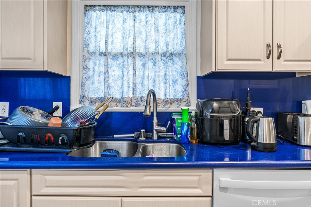 7977 Vista Del Rosa Street Downey, CA 90240 - Photo 13 of 53 a kitchen with a stove and a cabinets