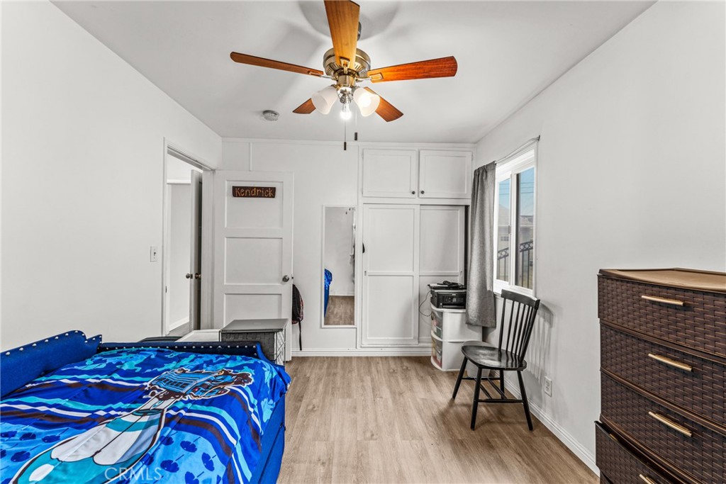 7977 Vista Del Rosa Street Downey, CA 90240 - Photo 20 of 53 a bedroom with a bed and a chair with the wooden floor