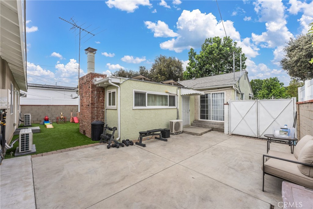 7977 Vista Del Rosa Street Downey, CA 90240 - Photo 26 of 53 a view of a house with a patio