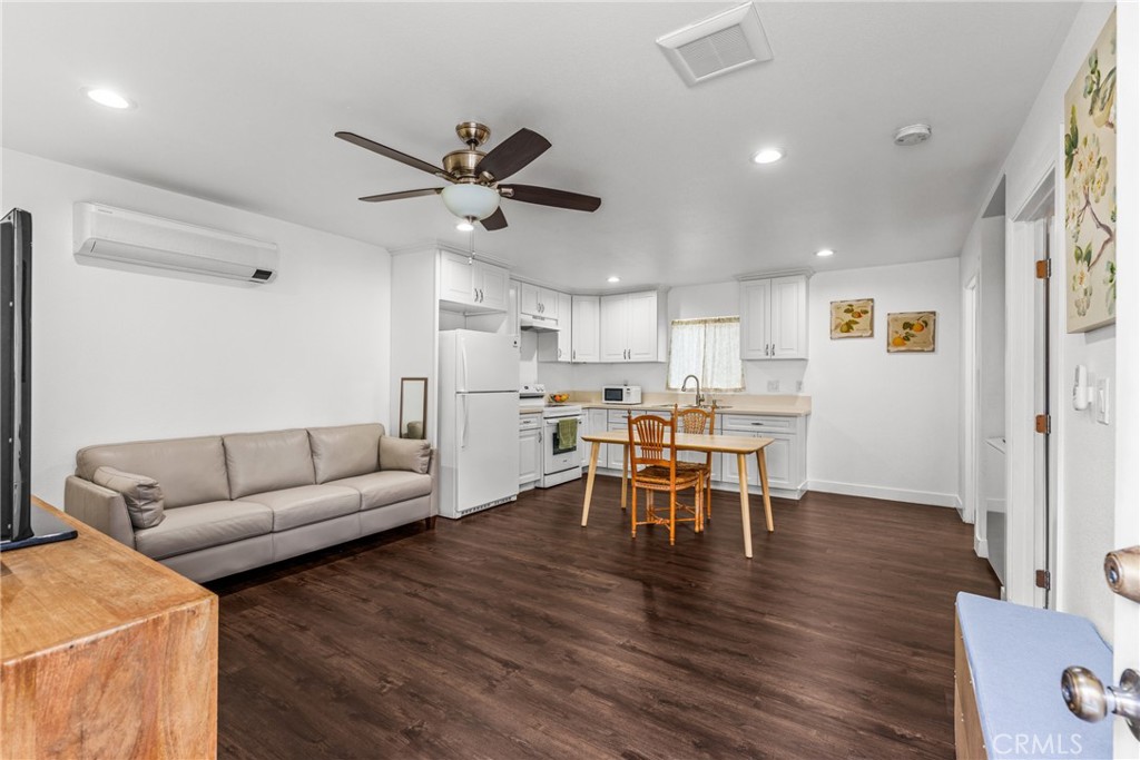 7977 Vista Del Rosa Street Downey, CA 90240 - Photo 30 of 53 a living room with furniture kitchen view and a dining table