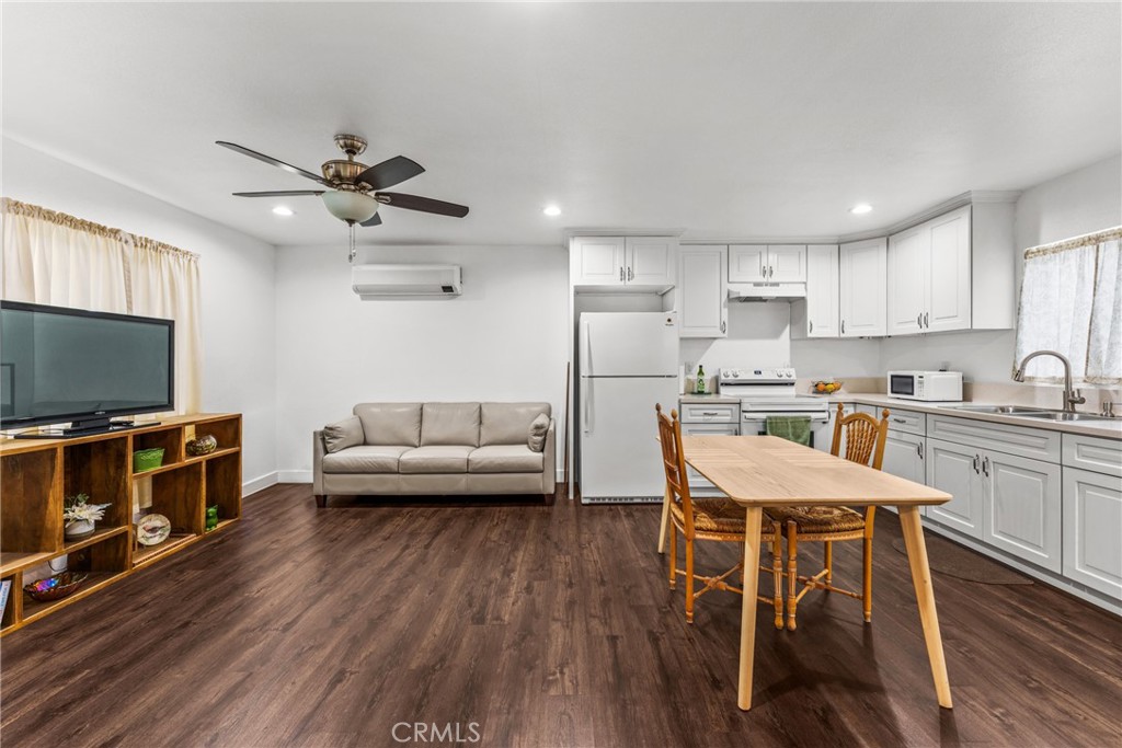 7977 Vista Del Rosa Street Downey, CA 90240 - Photo 31 of 53 a living room with furniture and a flat screen tv