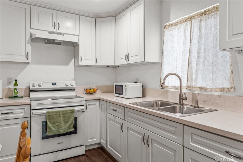 7977 Vista Del Rosa Street Downey, CA 90240 - Photo 33 of 53 a kitchen with cabinets appliances a sink and a counter top
