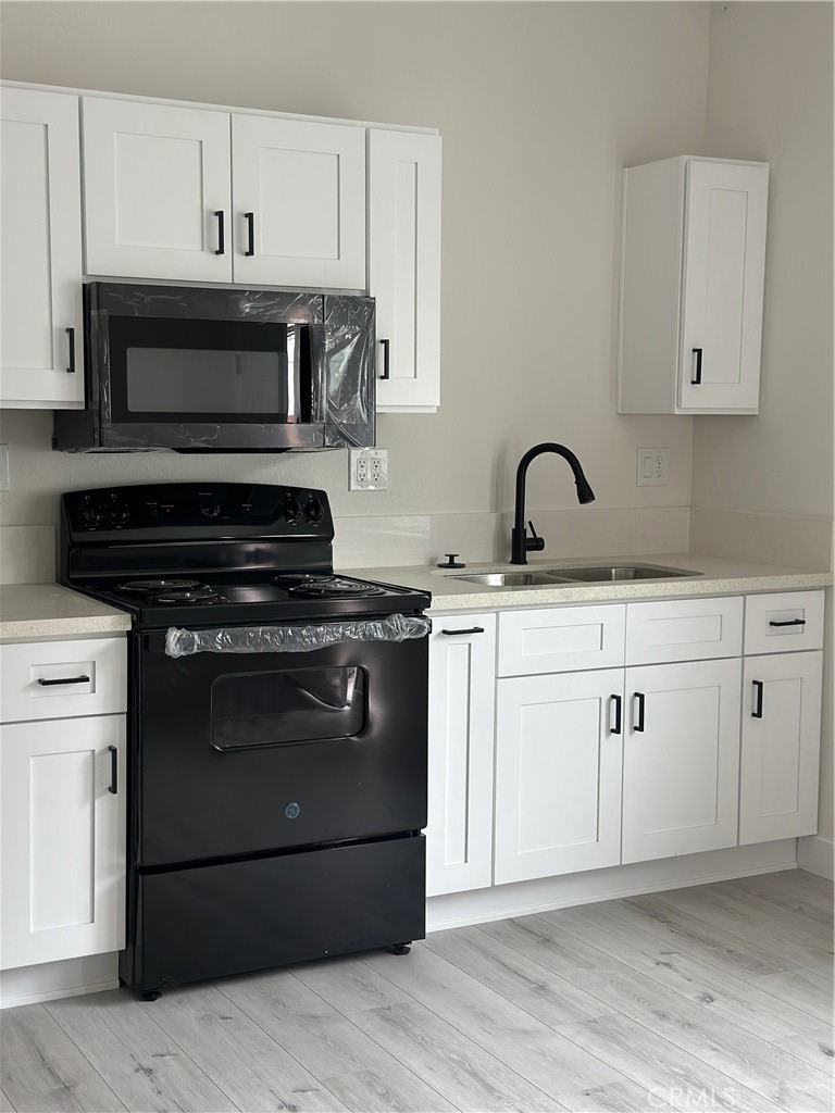 7977 Vista Del Rosa Street Downey, CA 90240 - Photo 41 of 53 a kitchen with cabinets appliances and a sink