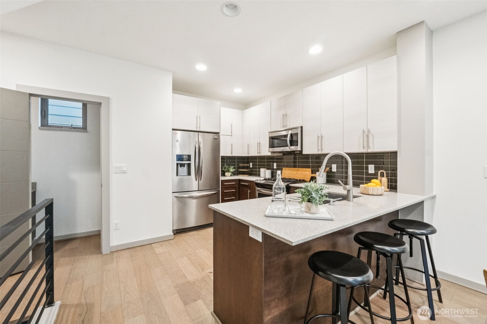 10503 Evanston Avenue North, Unit C Seattle, WA 98133 - Photo 11 of 25 a kitchen with stainless steel appliances a refrigerator and a stove top oven
