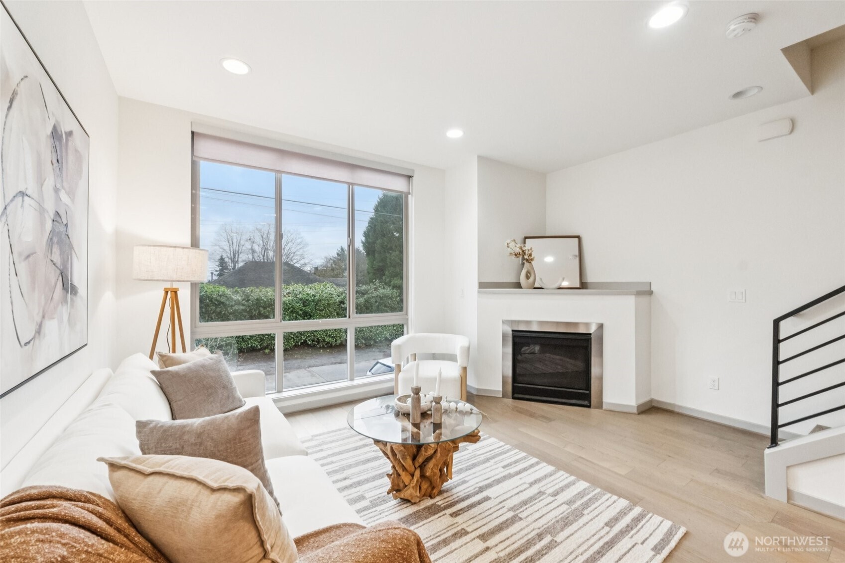 10503 Evanston Avenue North, Unit C Seattle, WA 98133 - Photo 13 of 25 a living room with furniture fireplace and a large window