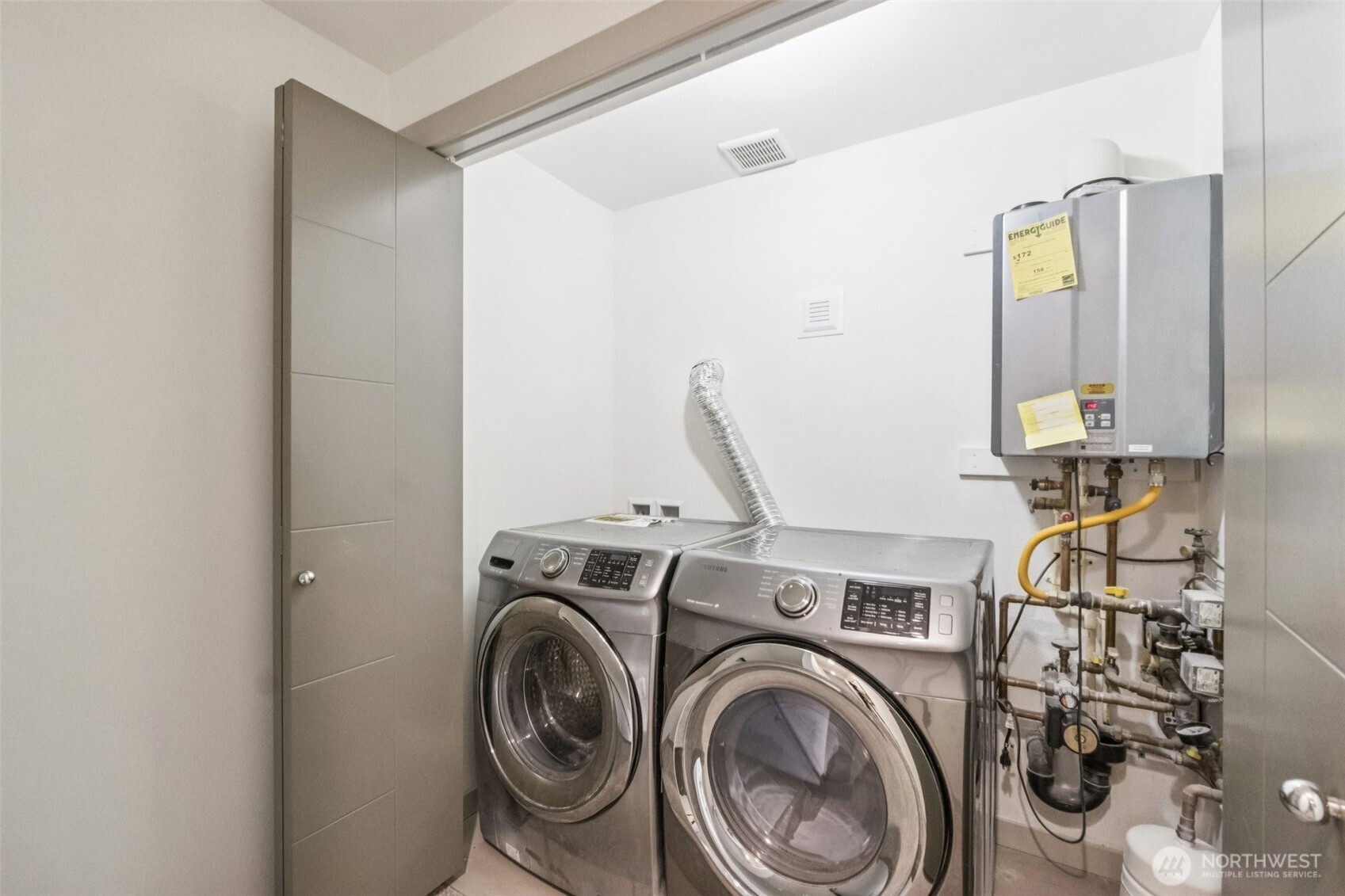 10503 Evanston Avenue North, Unit C Seattle, WA 98133 - Photo 15 of 25 a view of storage and utility room with washer and dryer