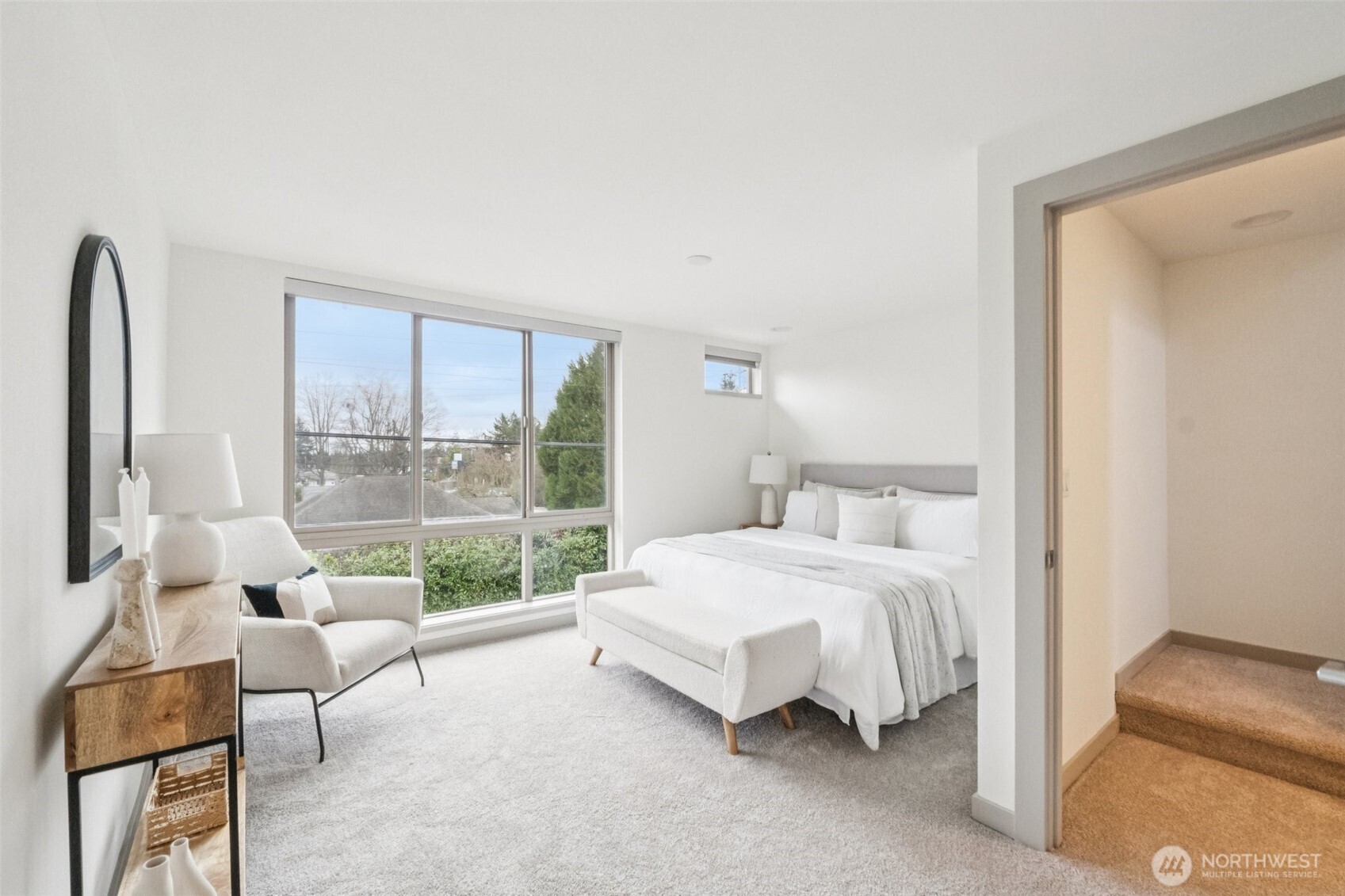 10503 Evanston Avenue North, Unit C Seattle, WA 98133 - Photo 16 of 25 a bedroom with a bed and large window