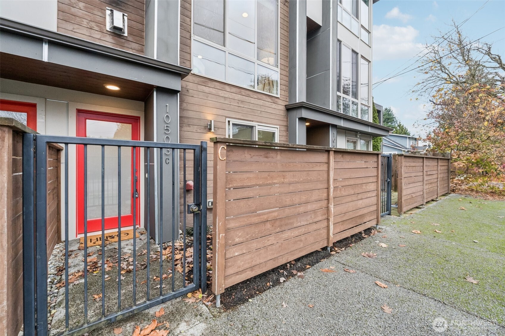 10503 Evanston Avenue North, Unit C Seattle, WA 98133 - Photo 2 of 25 a view of a house with a wooden fence