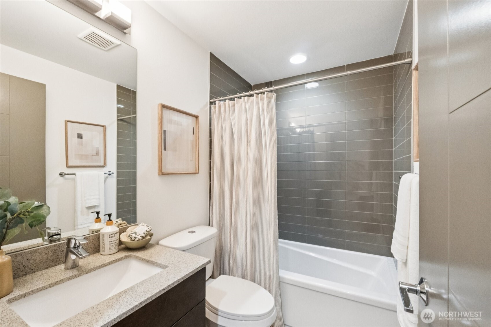 10503 Evanston Avenue North, Unit C Seattle, WA 98133 - Photo 5 of 25 a bathroom with a sink toilet and shower
