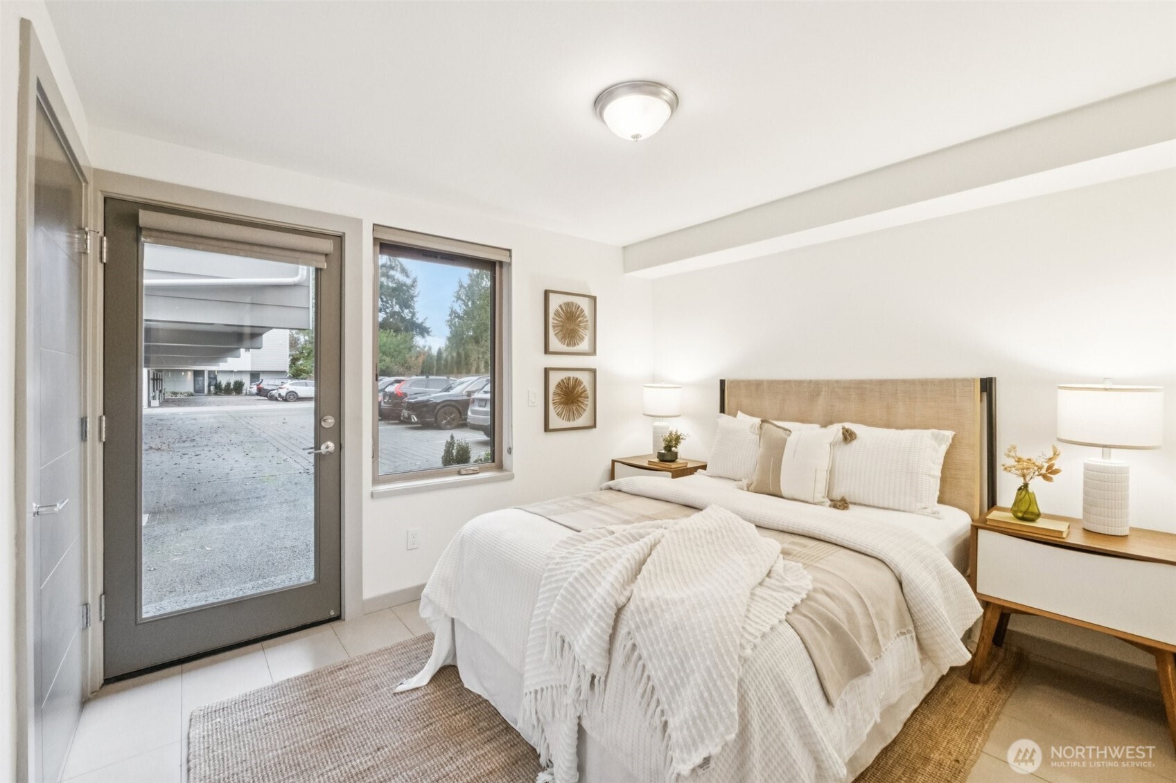 10503 Evanston Avenue North, Unit C Seattle, WA 98133 - Photo 6 of 25 a large bed sitting in a bedroom next to a window