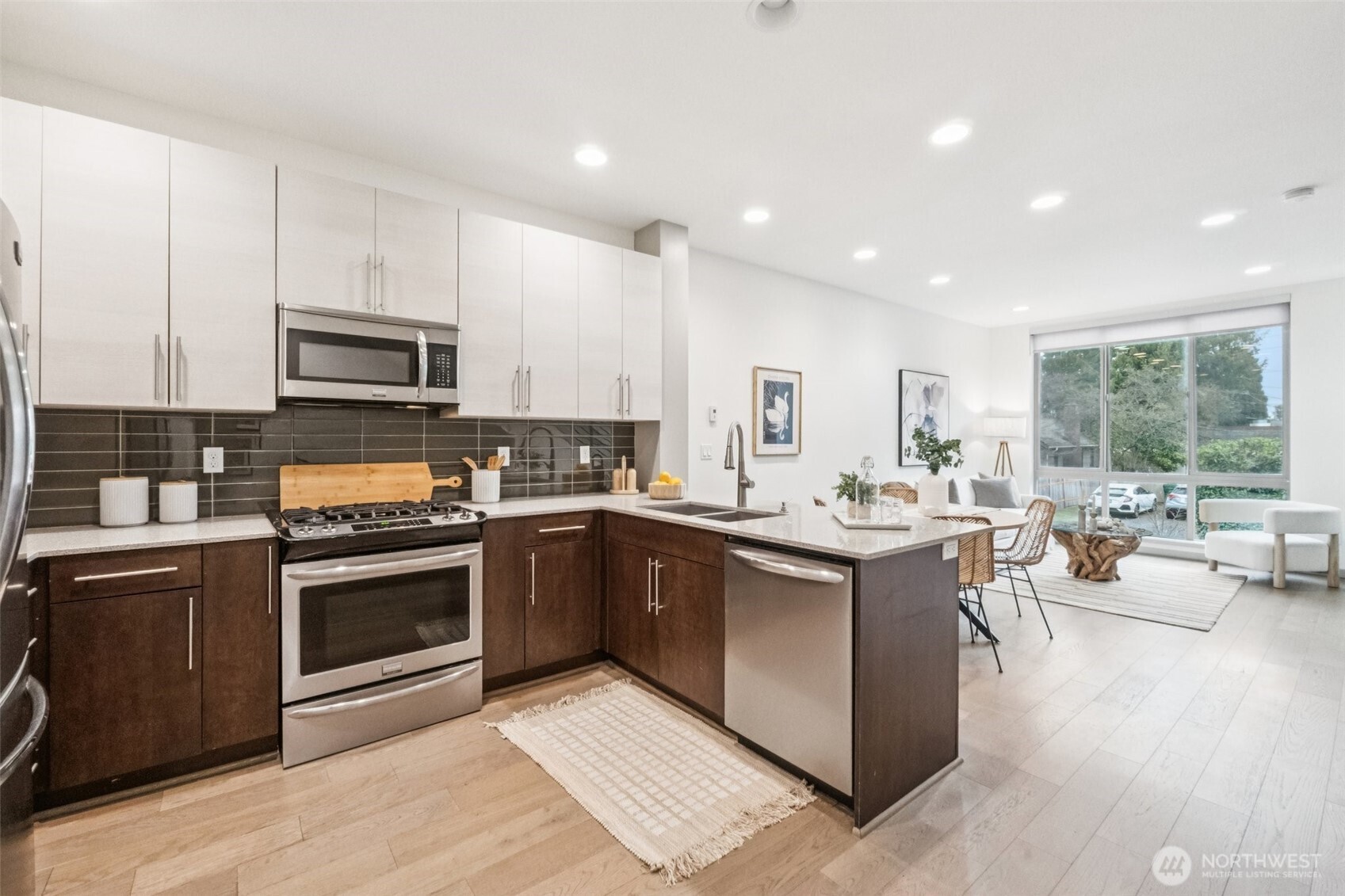 10503 Evanston Avenue North, Unit C Seattle, WA 98133 - Photo 10 of 25 a large kitchen with stainless steel appliances granite countertop a stove and a sink
