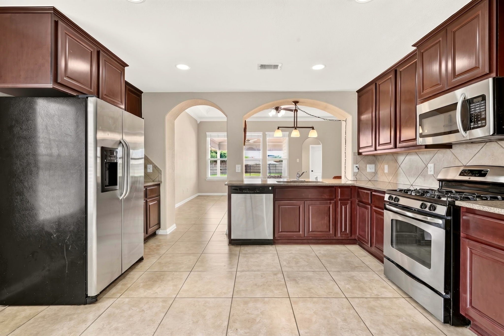 6446 Tea Tree Drive Katy, TX 77494 - Photo 5 of 39 14x10 Kitchen -
Enjoy preparing meals for family and friends in this spacious kitchen with lots of natural light and a view of the pool.