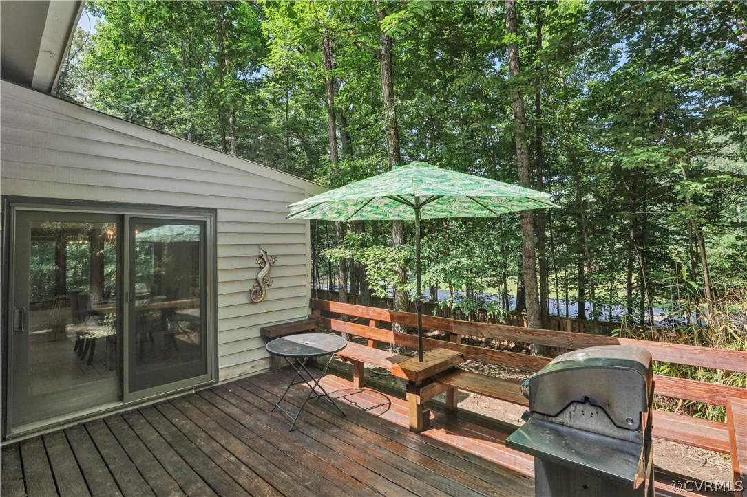 3307 7 Oaks Road Midlothian, VA 23112 - Photo 29 of 33 a backyard of a house with table and chairs under an umbrella