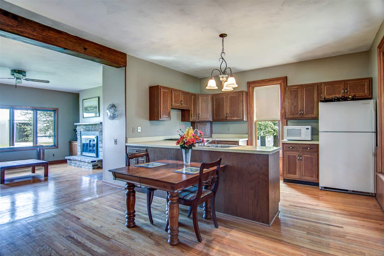 300 Manchester Road South Beloit, IL 61080 - Photo 15 of 18 a kitchen with a refrigerator a stove dining table and chairs