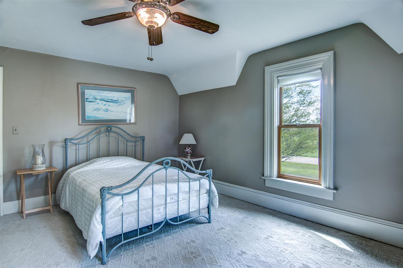 300 Manchester Road South Beloit, IL 61080 - Photo 18 of 18 a bedroom with a bed lamp and a window