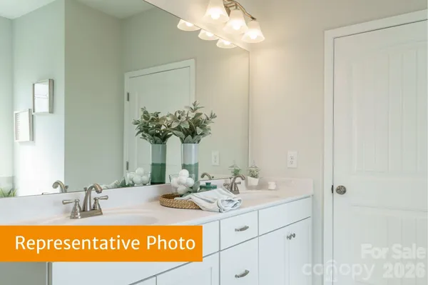 a bathroom with a sink a mirror and a vanity