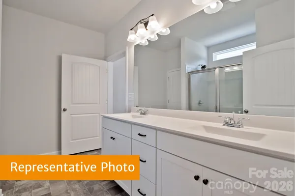 a bathroom with a sink mirror and vanity