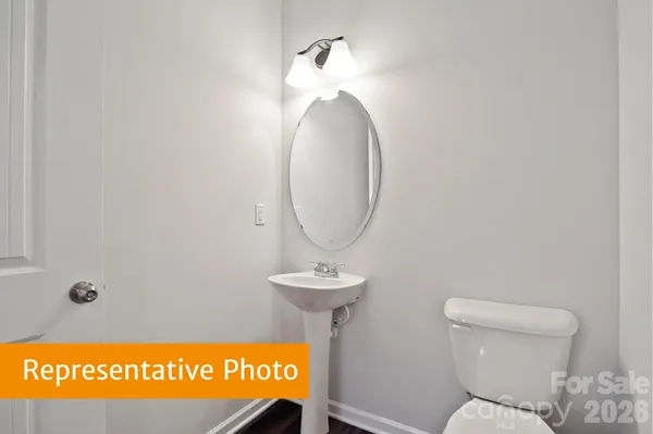 a bathroom with a toilet and a mirror