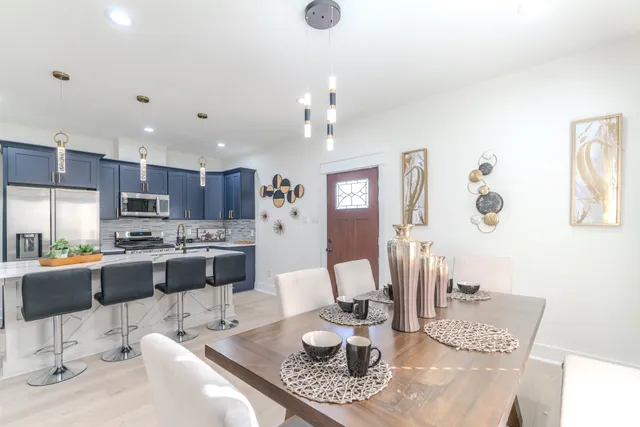 a living room with kitchen island furniture and a chandelier