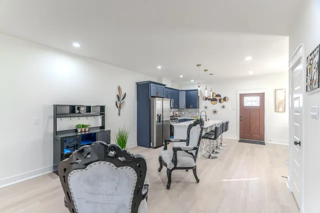 a living room with furniture and kitchen view