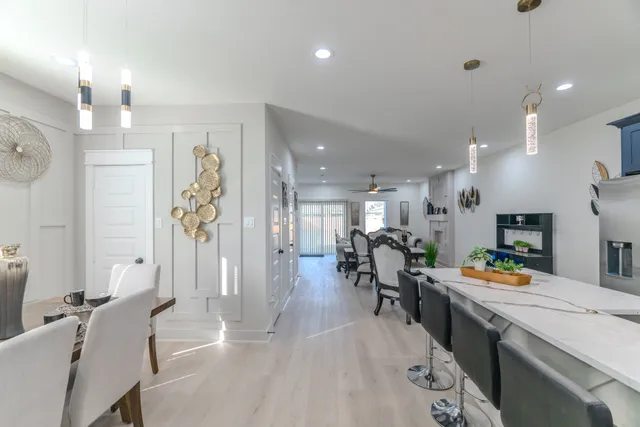 a large kitchen with a table and chairs