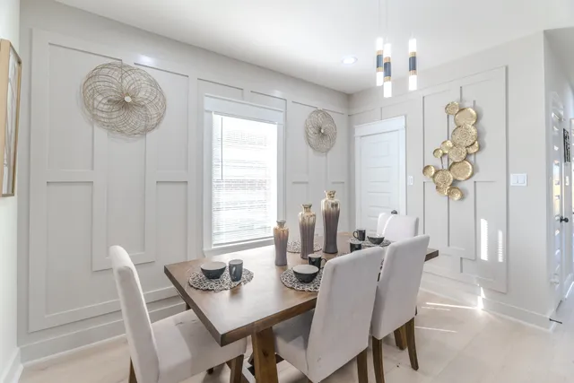 a view of a dining room with furniture and chandelier