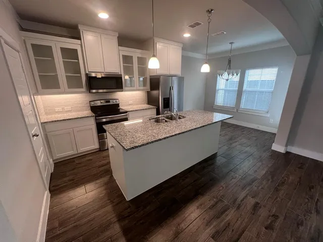 a white toilet sitting next to a bathroom sink