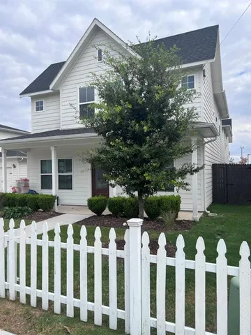 a front view of house with wooden fence