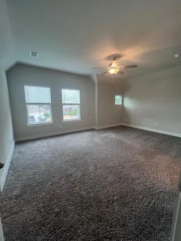 an empty room with windows and closet