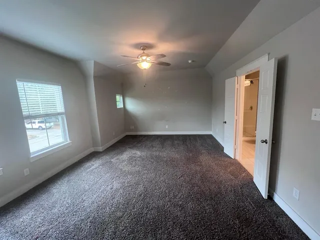 a spacious bathroom with a granite countertop sink a toilet and shower