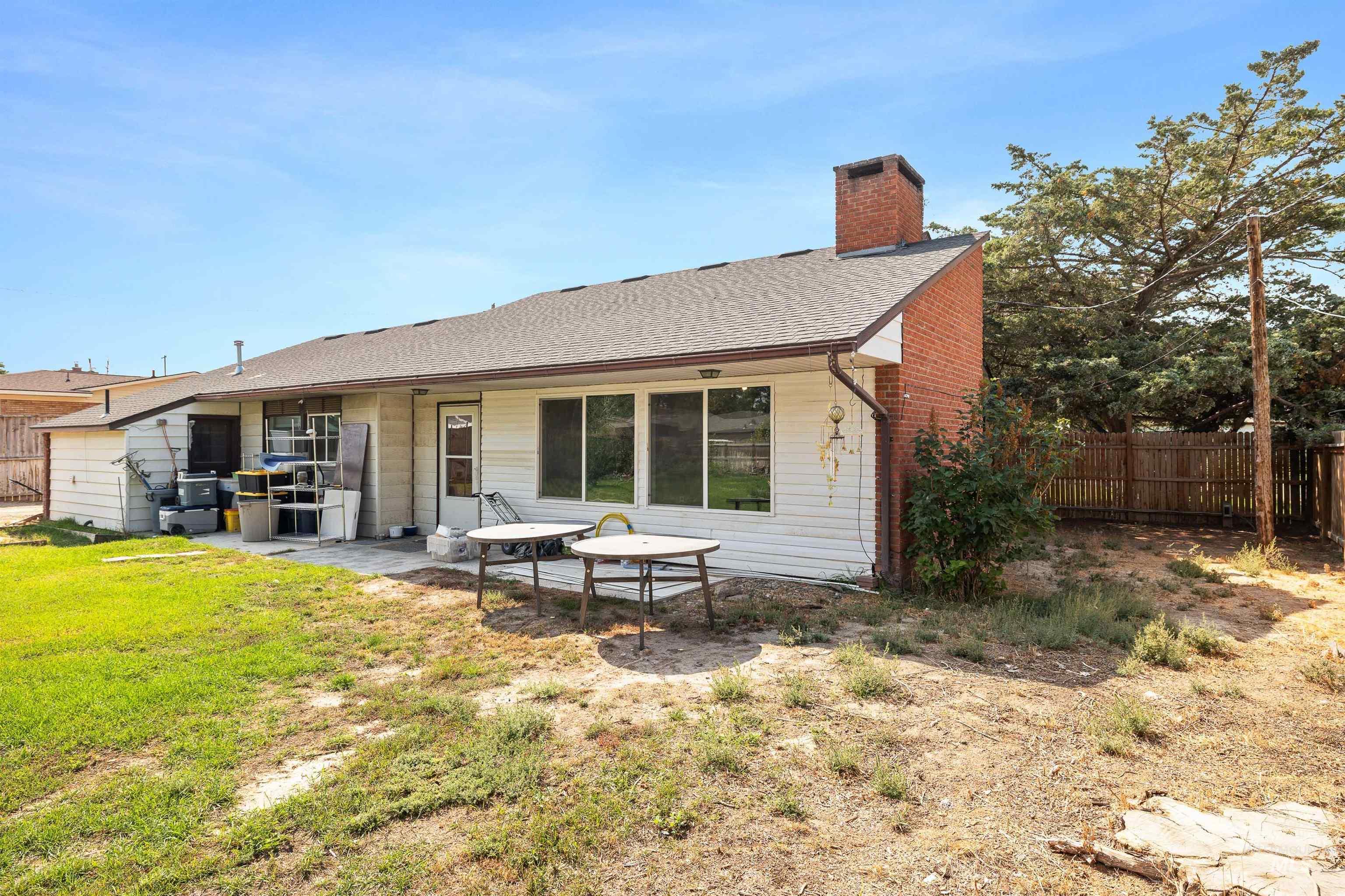 817 Union Avenue Filer, ID 83328 - Photo 28 of 37 Back of property featuring a patio area, a chimney, and roof with shingles