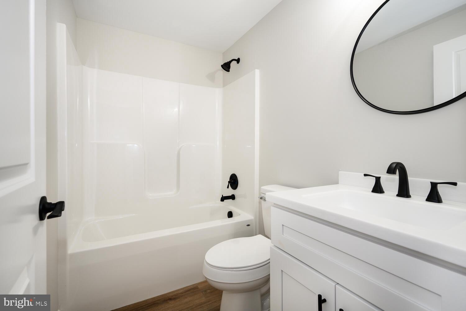 14 North Maple Avenue Ridgely, MD 21660 - Photo 15 of 19 a bathroom with a sink a toilet and a mirror