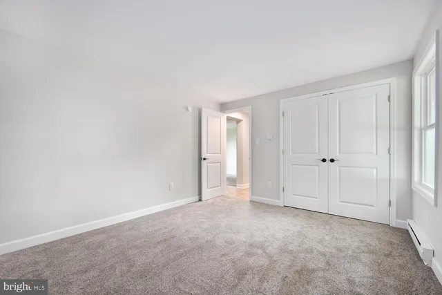 a view of an empty room and closet area