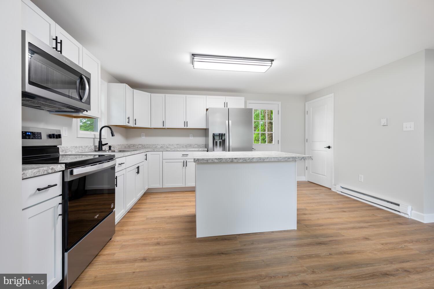 14 North Maple Avenue Ridgely, MD 21660 - Photo 8 of 19 a kitchen with granite countertop a sink cabinets stainless steel appliances and a window