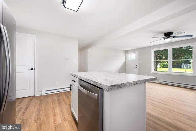 a view of a kitchen cabinets a sink and wooden floor